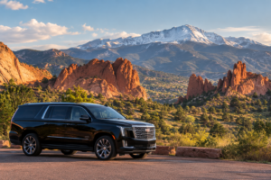 Black luxury SUV near Garden of the Gods red rock formations